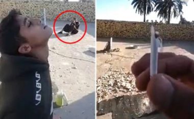 Babai përdor djalin si tabelë qitjeje, momenti kur gjuan me armë cigaren që gojën e të miturit (VIDEO)