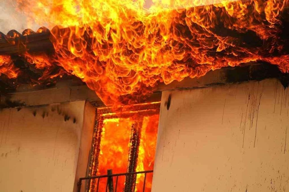 A home engulfed in flames in the village of Trebosh in Tetovo